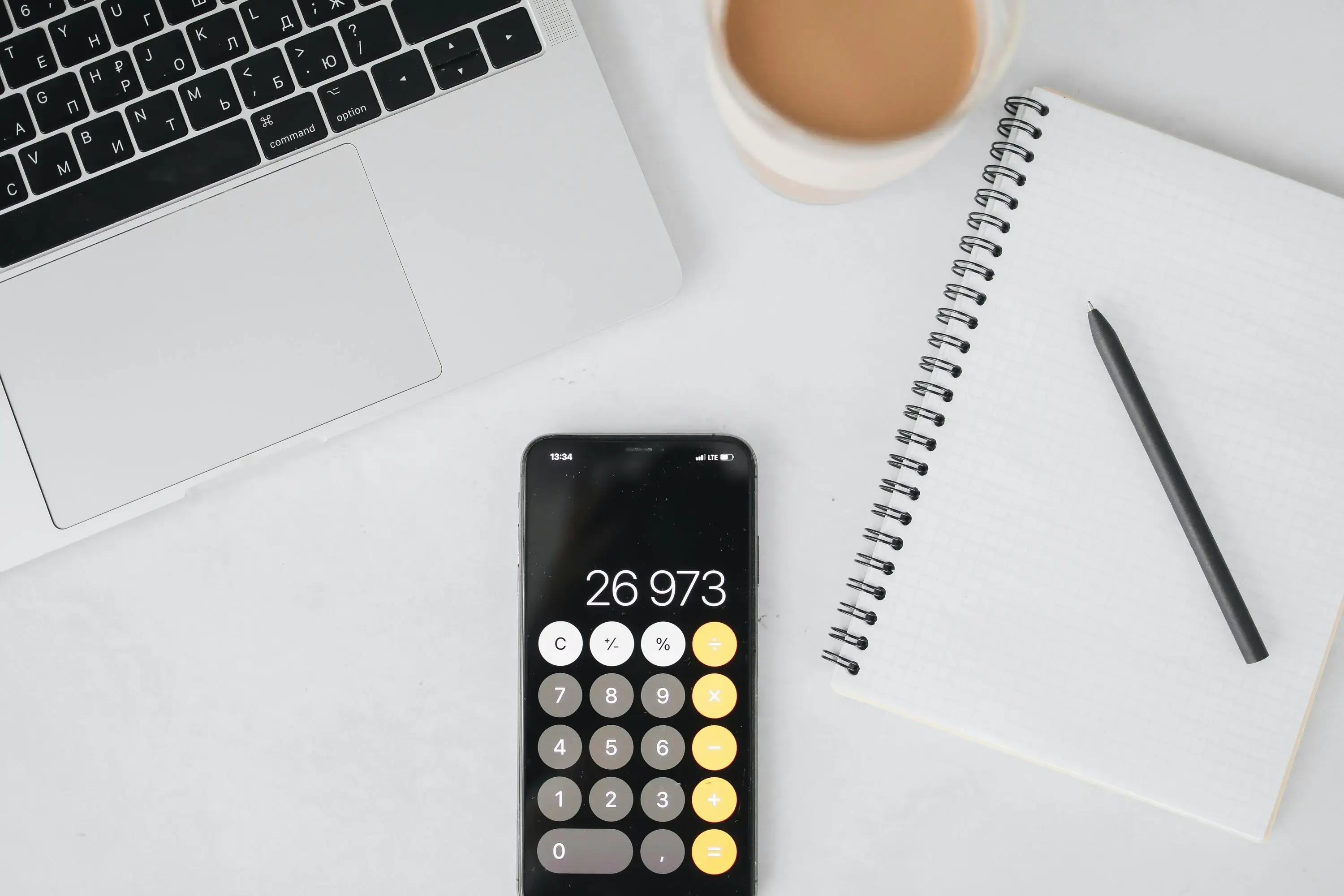 Laptop showing a website design with a calculator beside it